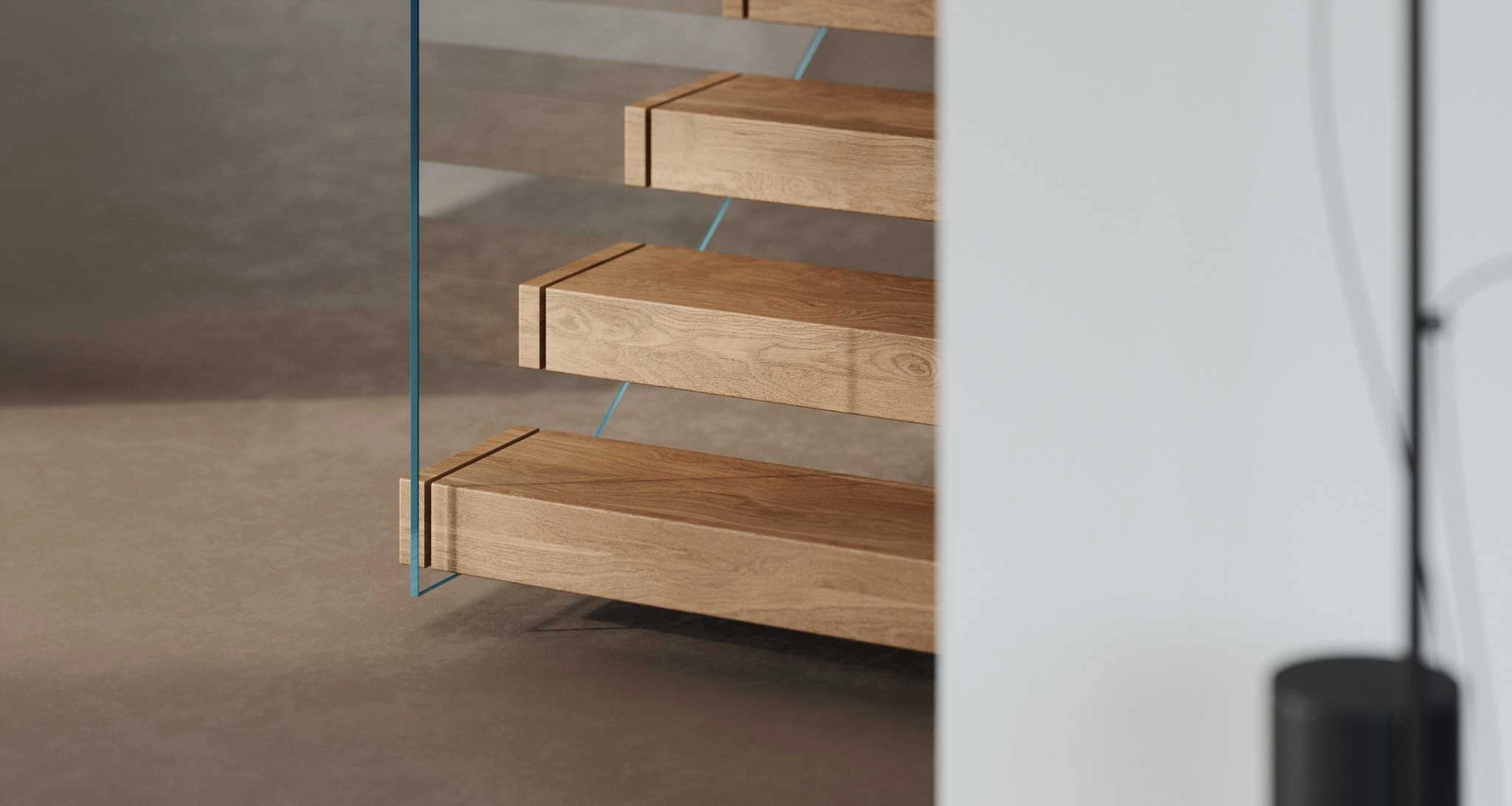 Three cantilevered treads seen through the glass railing at close range