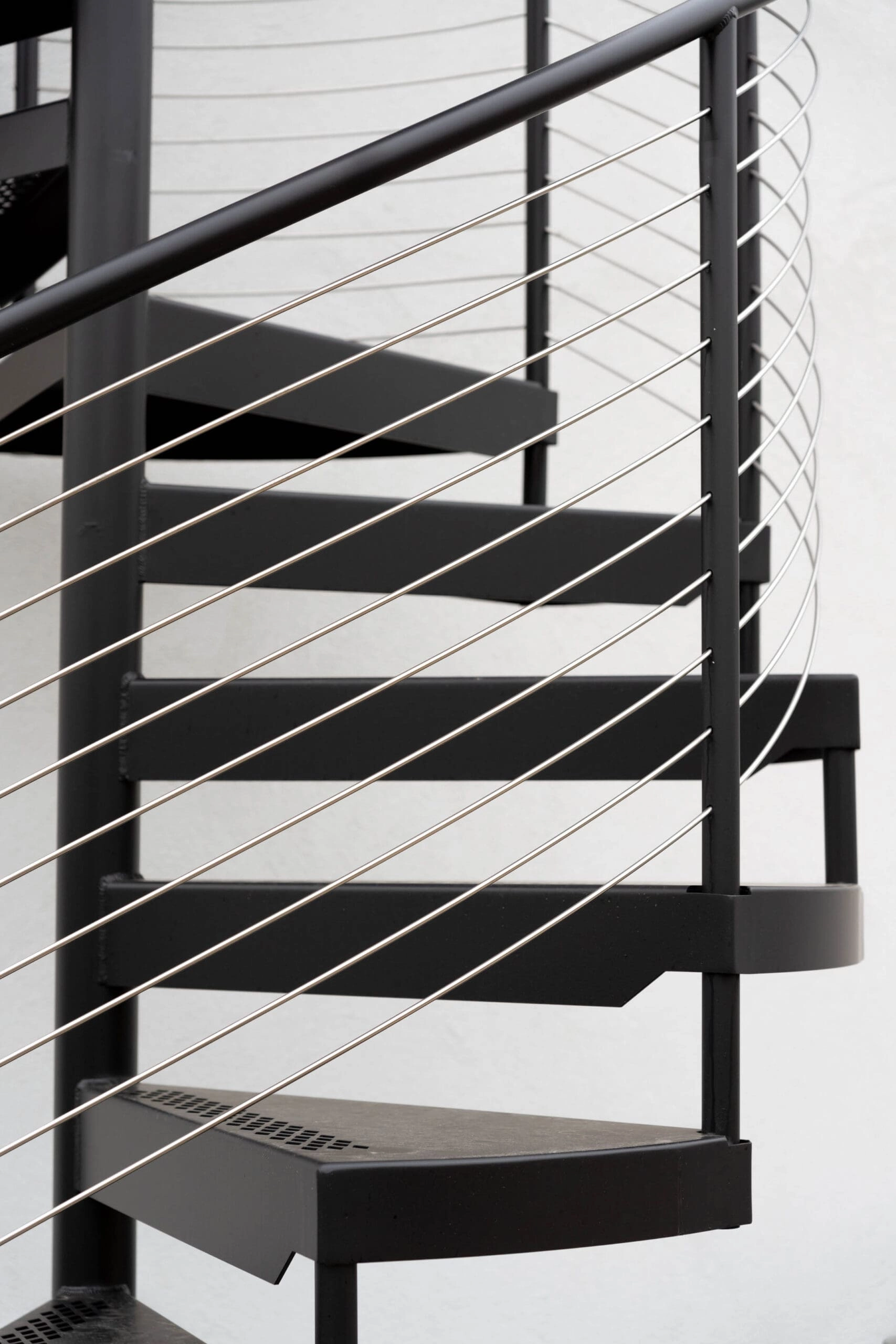 Underside view of spiral treads with cables angling behind the center column