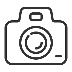 Black outline of a camera with a lens and flash on a transparent background.