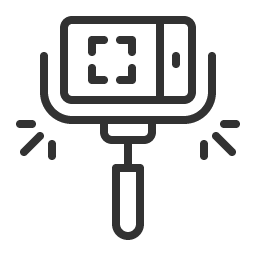 Icon of a smartphone mounted on a selfie stick with flash or light symbols on sides.