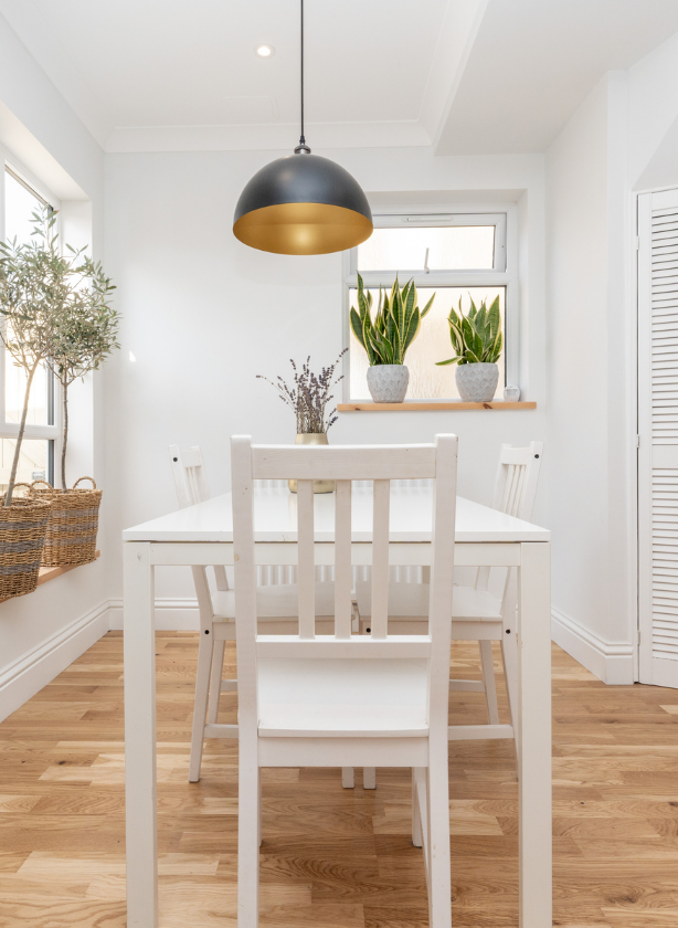 Rattan chair by a window with indoor plant