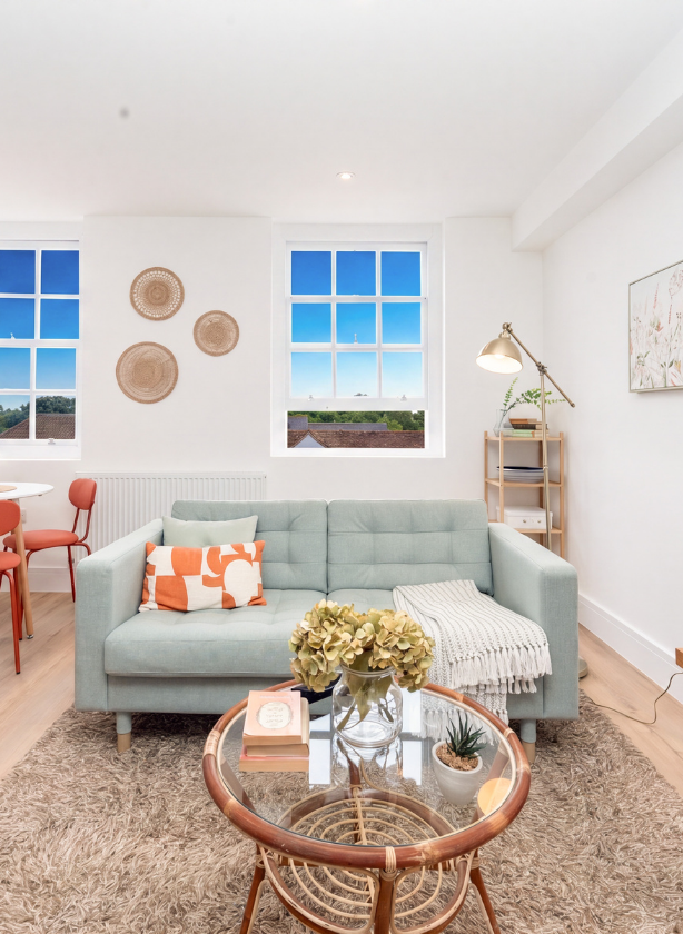 Sunlit living room with neutral tones and large glass doors