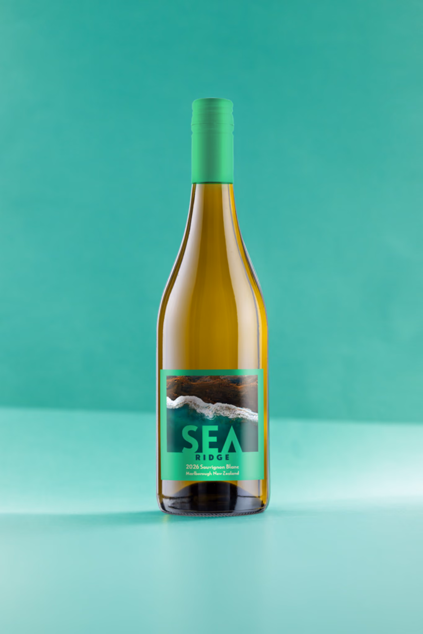 Bottle of SEA Ridge 2026 Sauvignon Blanc wine with teal label and cap on teal background.