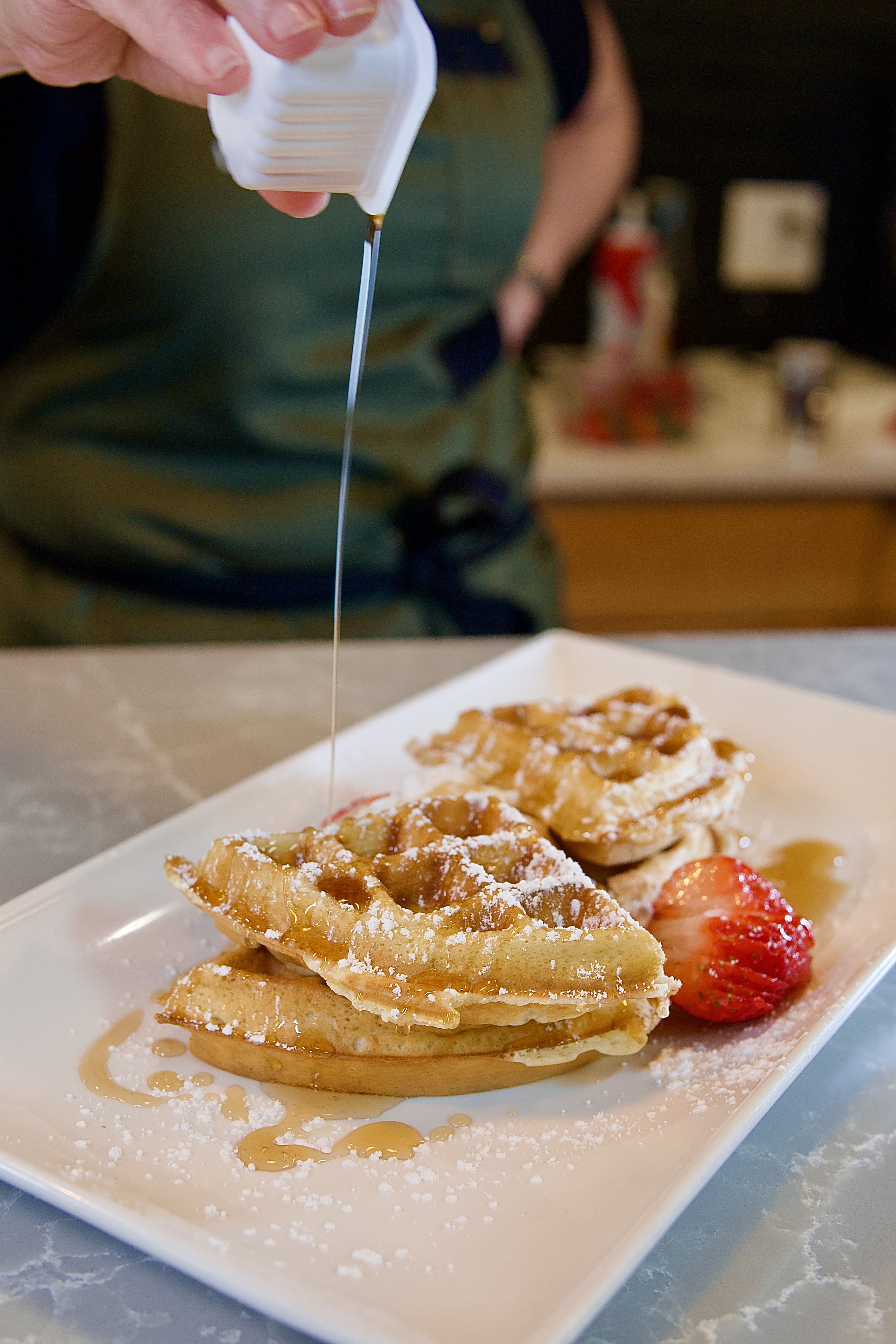Waffles with strawberries and syrup