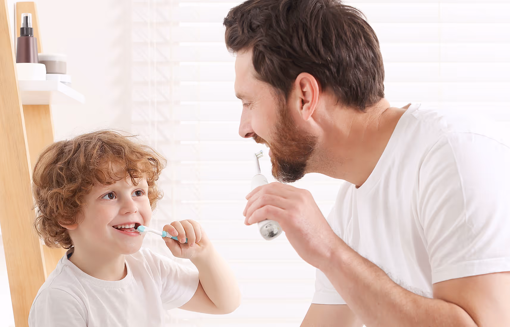father and son brushing teeth