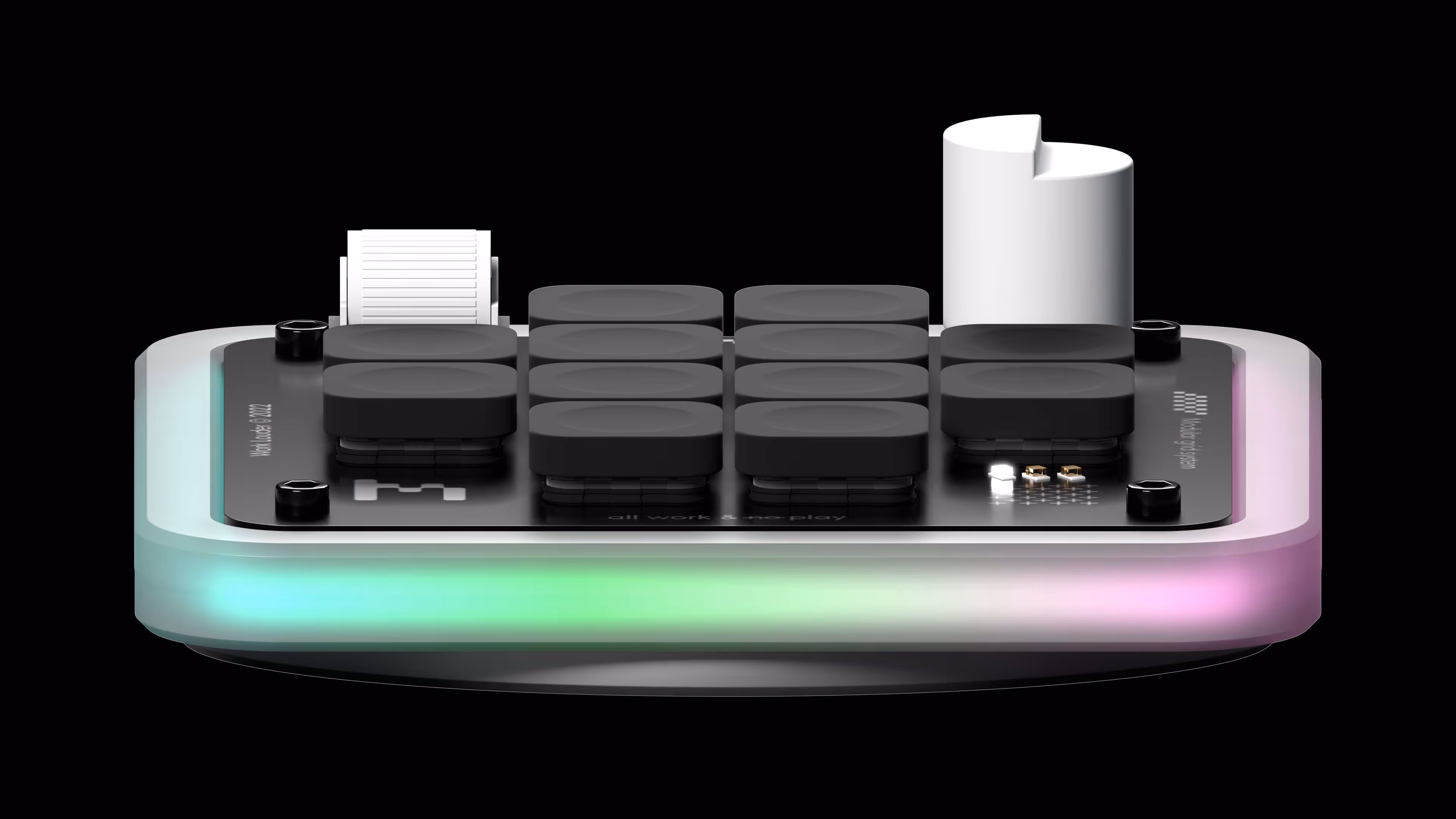 Compact device with ten black rounded buttons, a white dial, and RGB lighting base on black background.