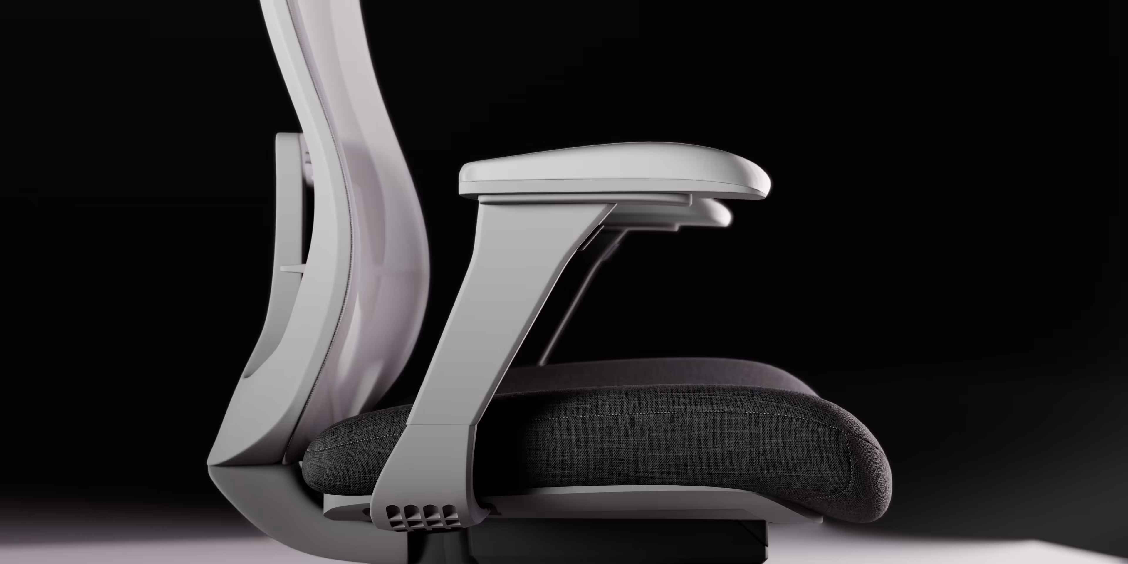 Side view of a modern office chair with a white frame and gray fabric seat cushion.