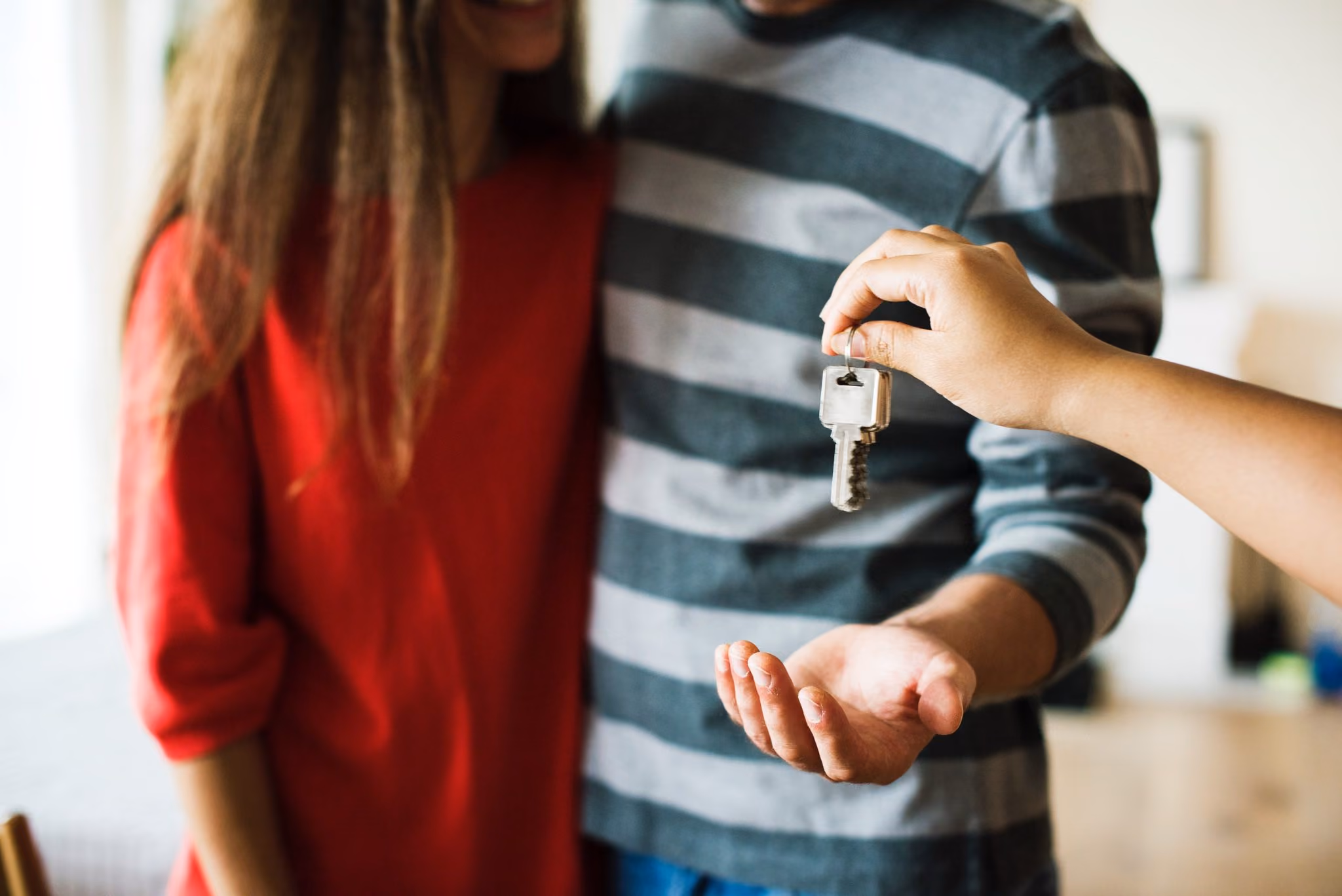 Young house buyers in Knoxville getting the keys to their new home.