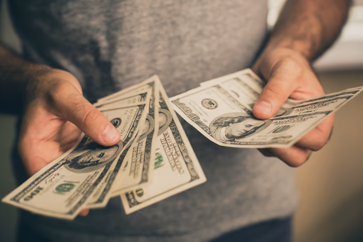 Man holding cash from selling house to a cash buyer in Chattanooga.