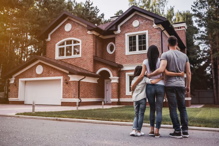 A family standing outside of a the house they are going to sell for cash in Hillsboro.