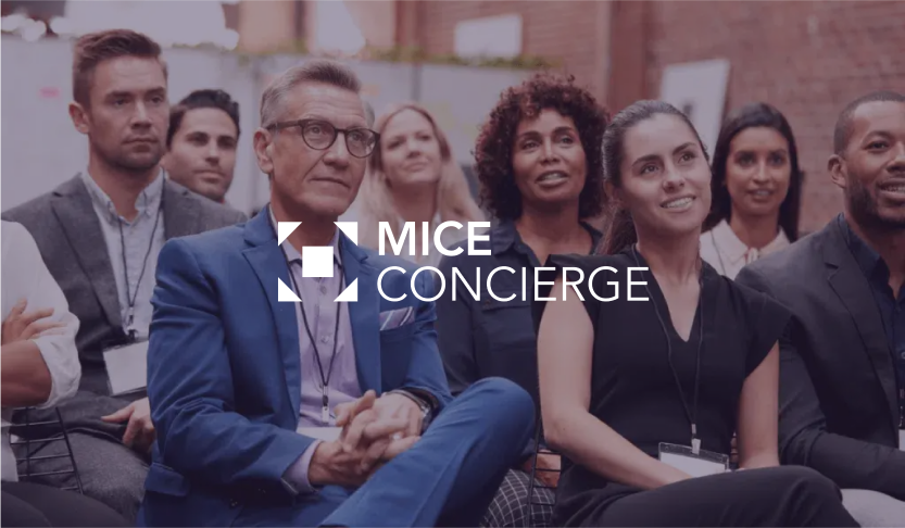 MICE Concierge logo over a group of delegates seated at a workshop session