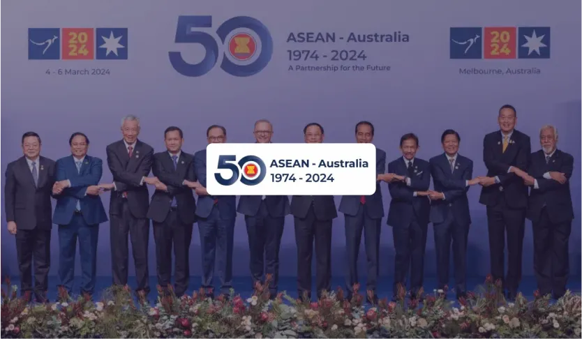ASEAN-Australia 1974-2024 logo over leaders linking hands for a summit family photo