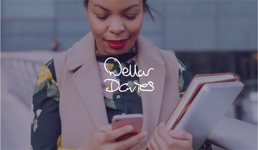 Dellar Davies logo over a woman holding notebooks and looking at her phone