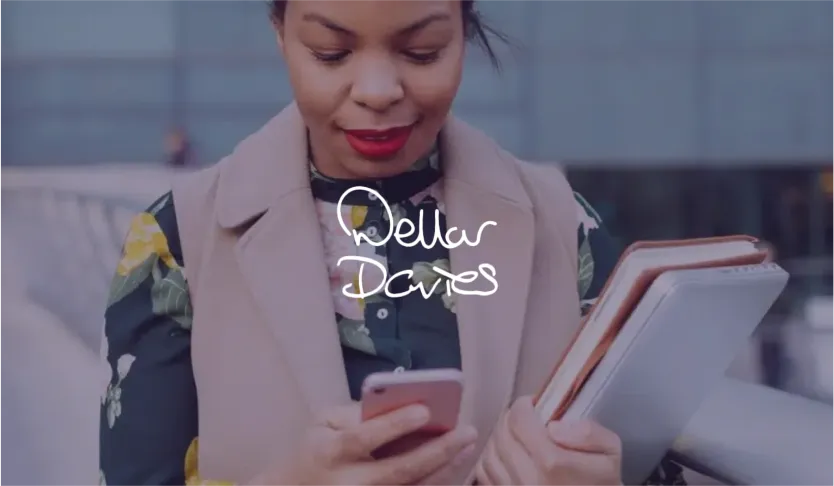 Dellar Davies logo over a woman holding notebooks and looking at her phone