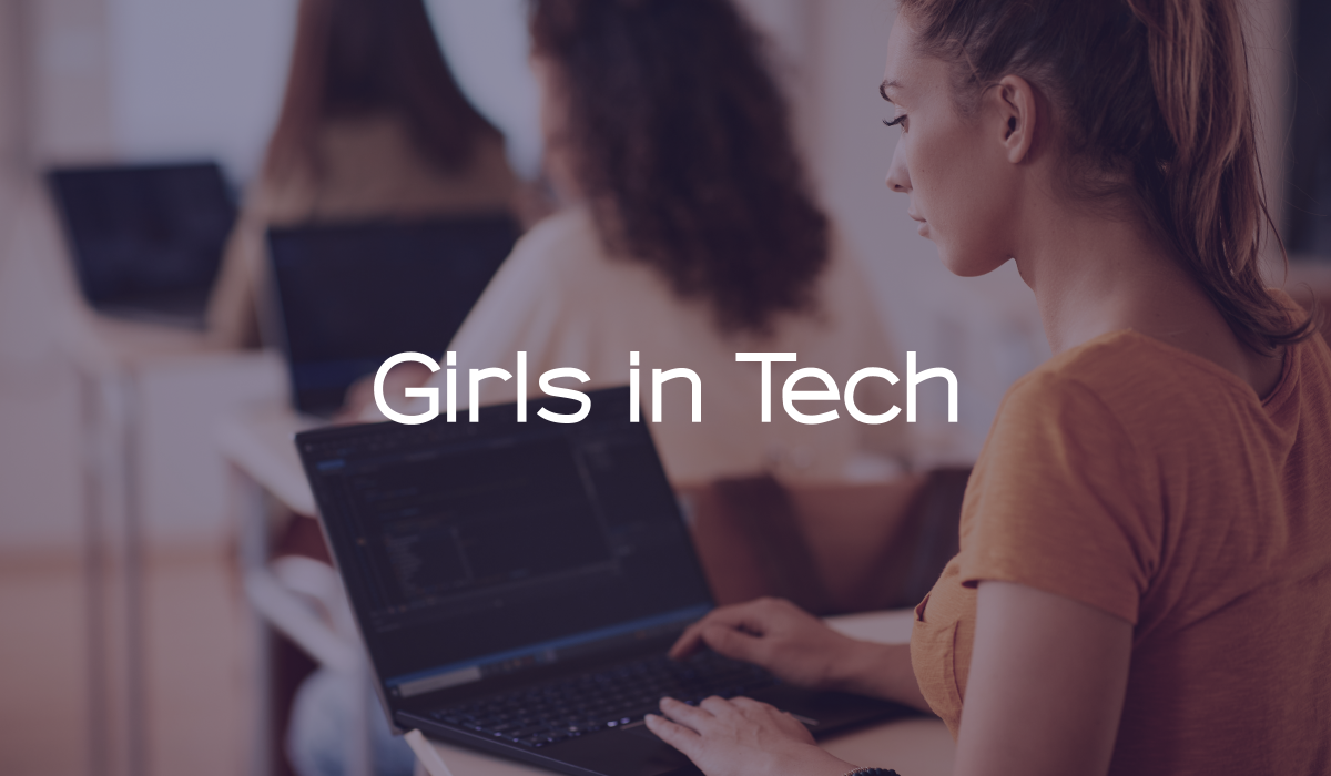 Girls in Tech logo over young women coding on laptops in a classroom