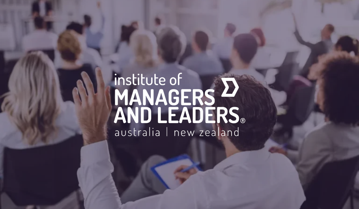 Institute of Managers and Leaders logo over seminar attendees raising their hands