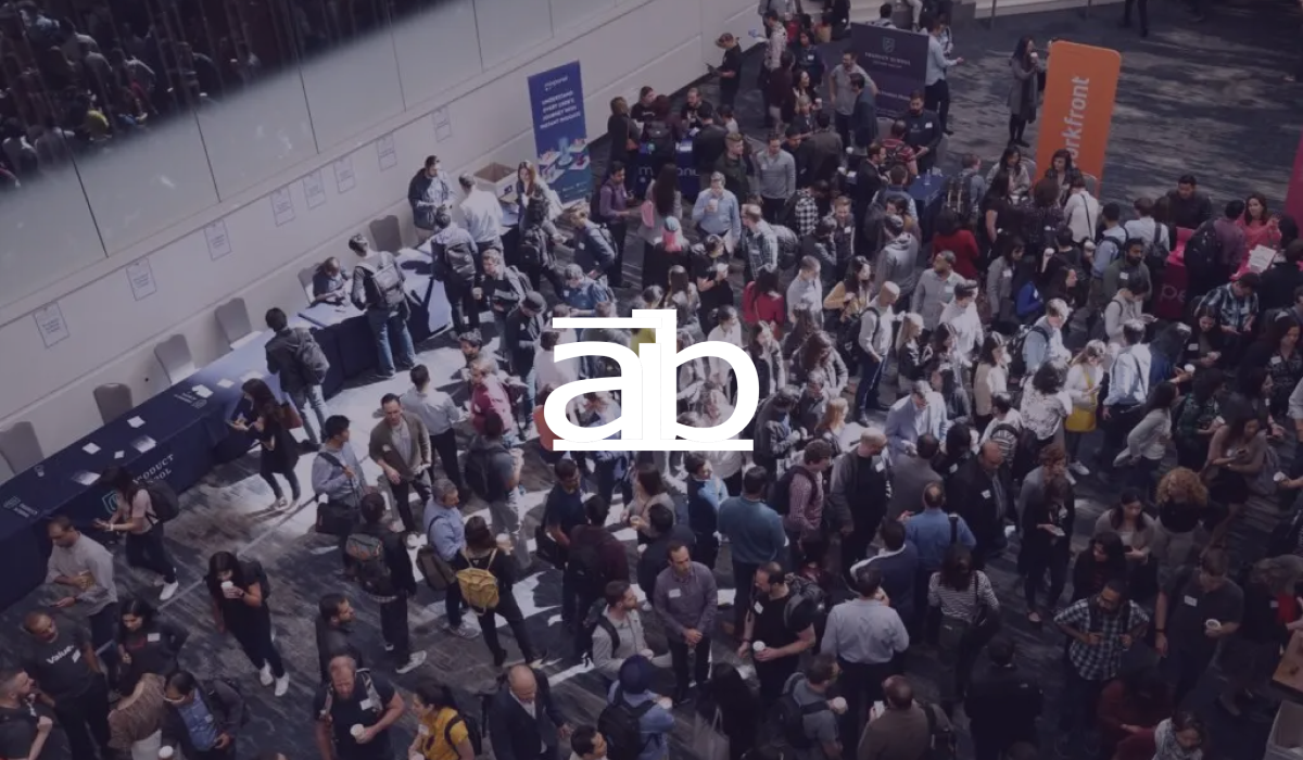 Academy of International Business logo over a crowded conference networking break
