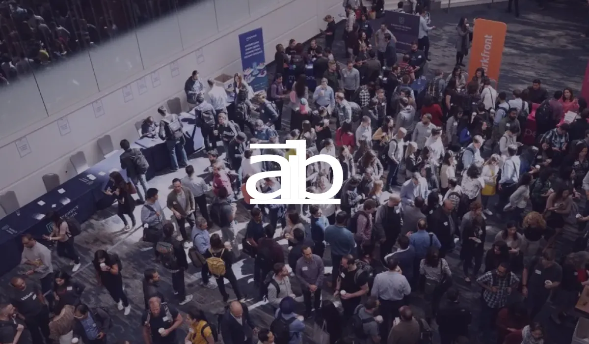 Academy of International Business logo over a crowded conference networking break