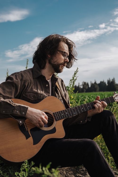 Ben Sluys Playing music in front of a corn field