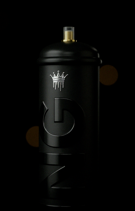 Matte black spray paint can with a silver dripping crown logo near the top and large embossed letters on the body, set against a dark background with subtle brownish bokeh lights.