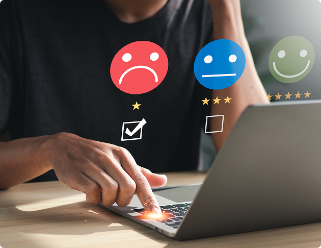 Person using laptop with a one-star sad face rating being selected on the screen.