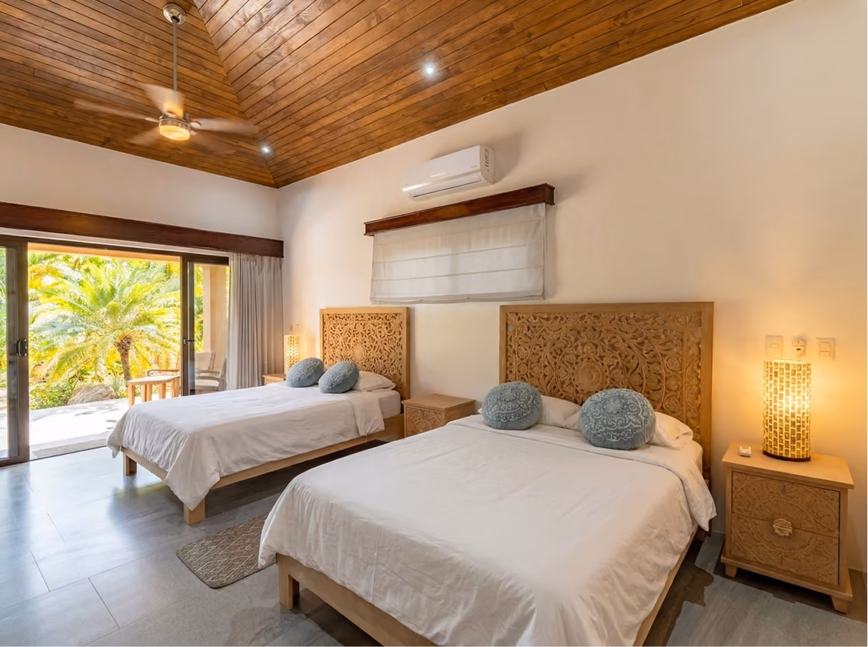 Guest room with private bed configuration at Paradise Villas