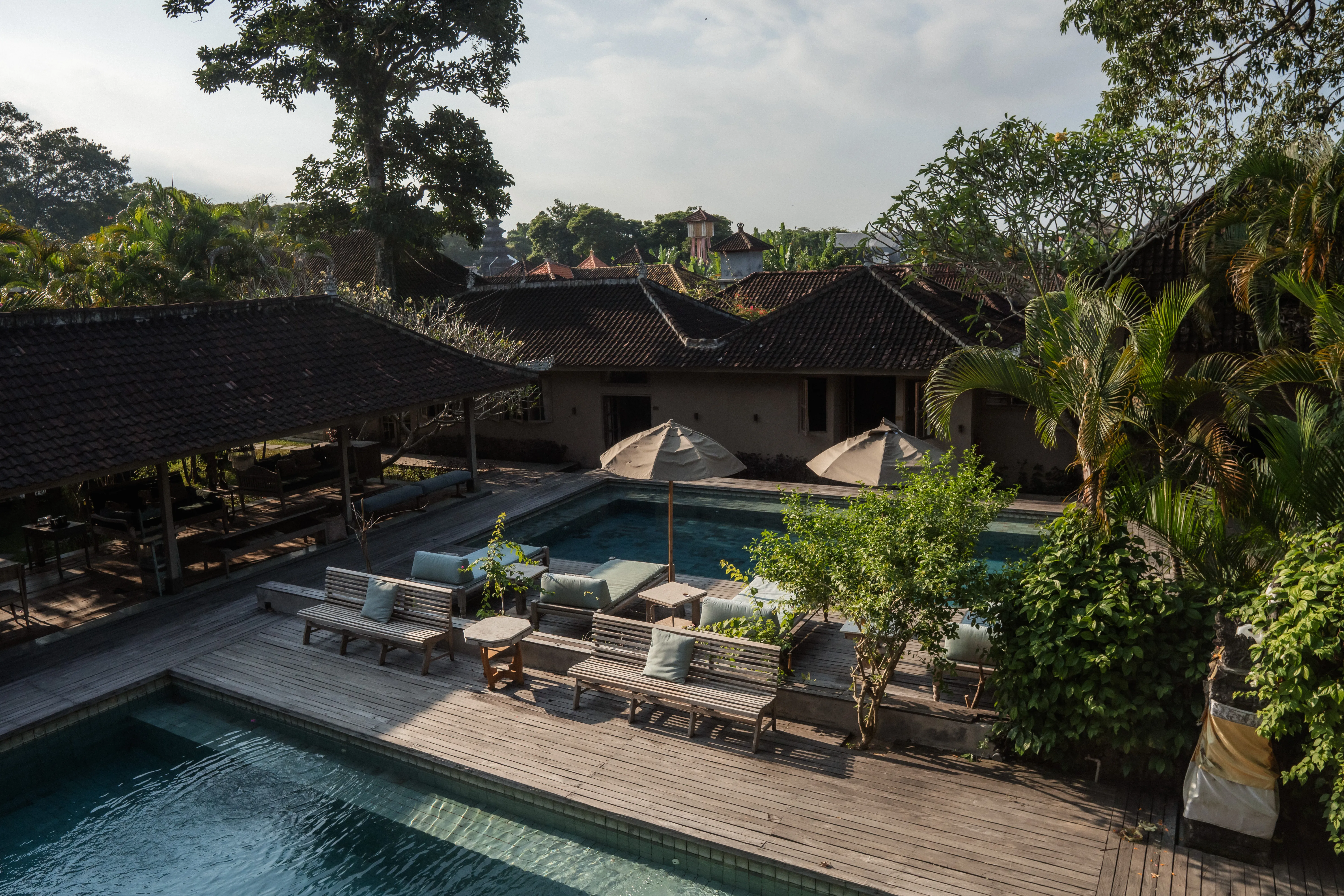 High angle view of the luxury outdoor swimming pool and sun loungers at The Shaba Shala retreat.