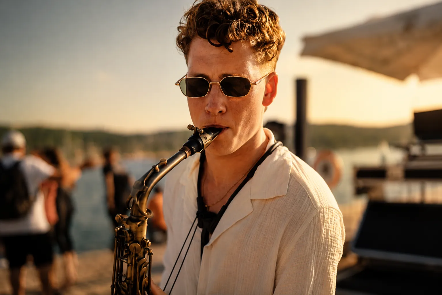 Outdoor dining area at night with guests seated and a saxophone player performing near a DJ booth.