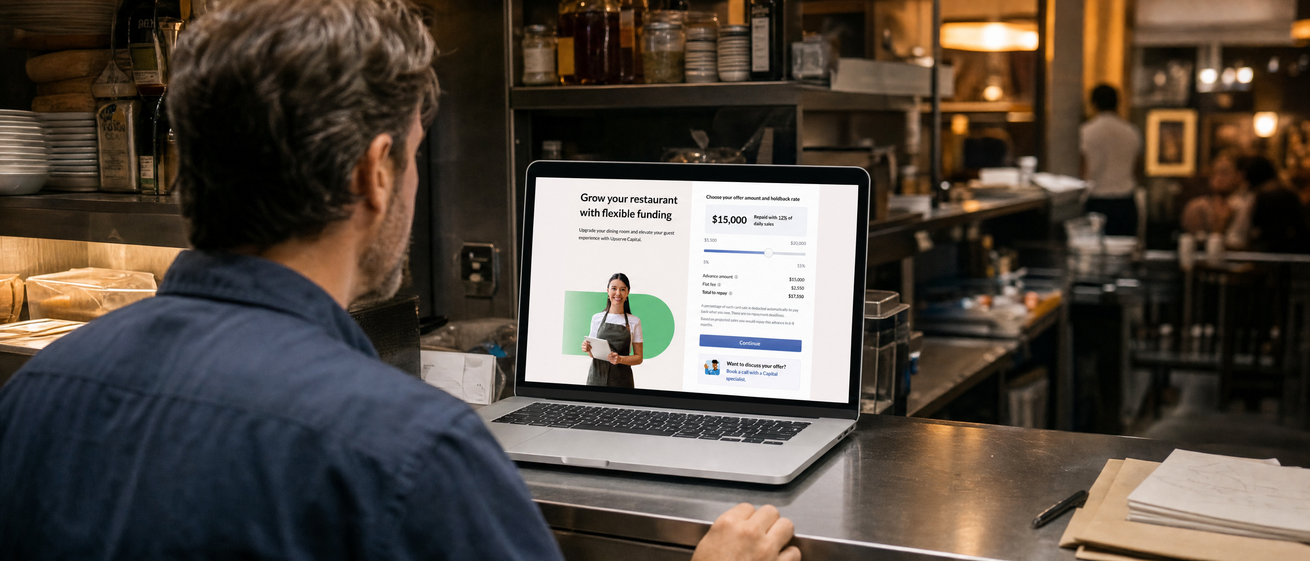 Restaurant owner reviewing an Upserve Capital funding offer on a laptop at the bar