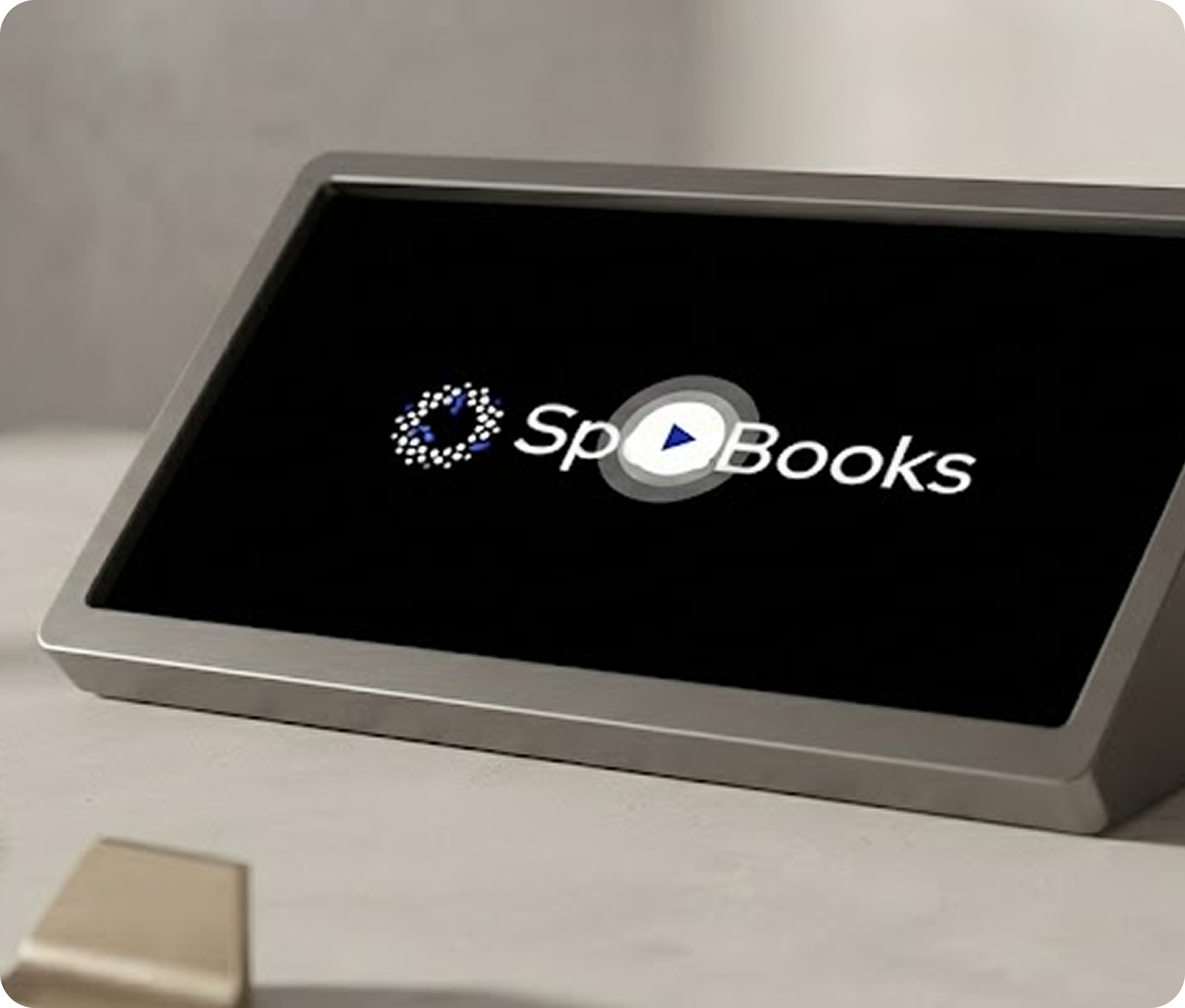 Digital device on a table displaying the logo Sp Books with a play button in the middle.