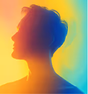Silhouette of a person looking up, lit with warm yellow and cool blue gradient lighting.