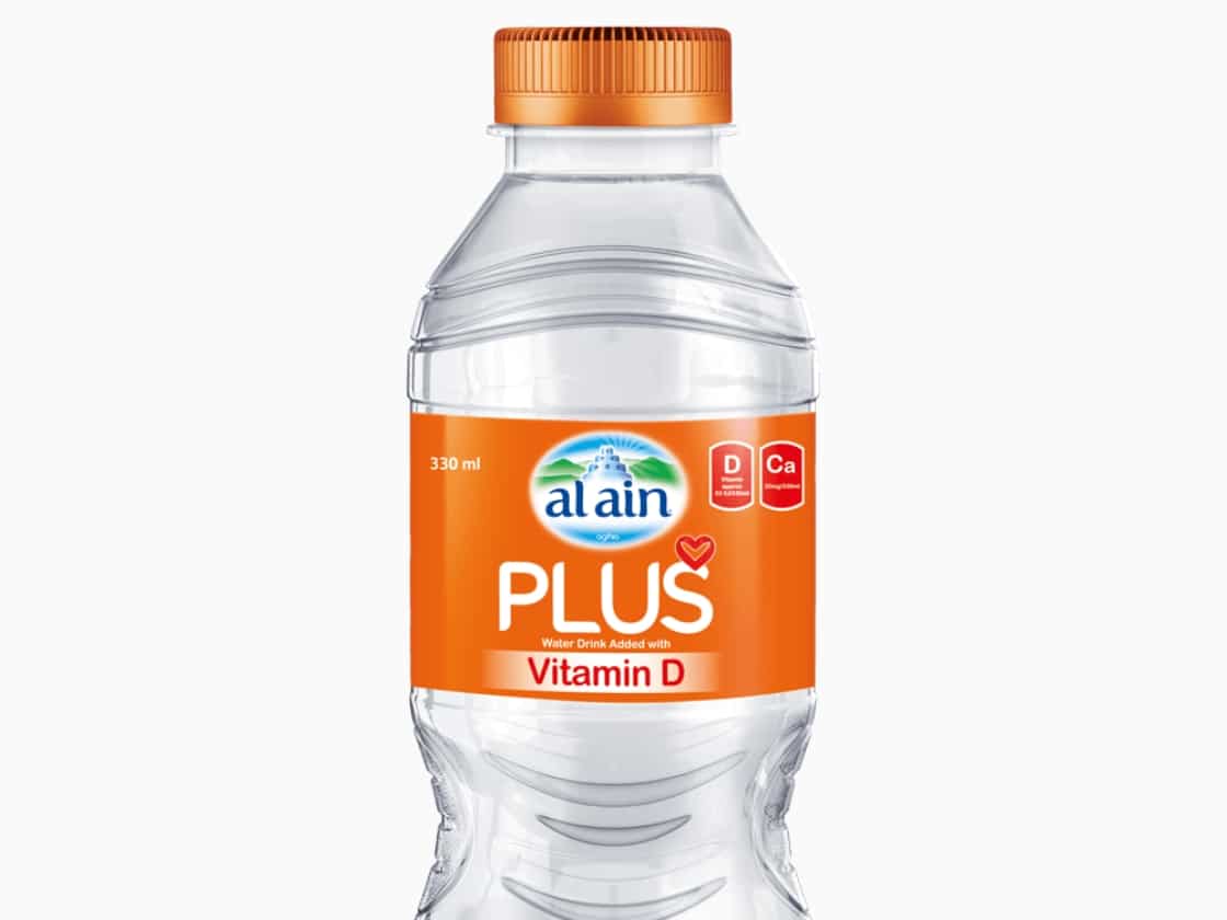 An Al Ain Plus vitamin D water bottle with the orange cap and label | Packaging Design and Brand Innovation, Al Ain Plus