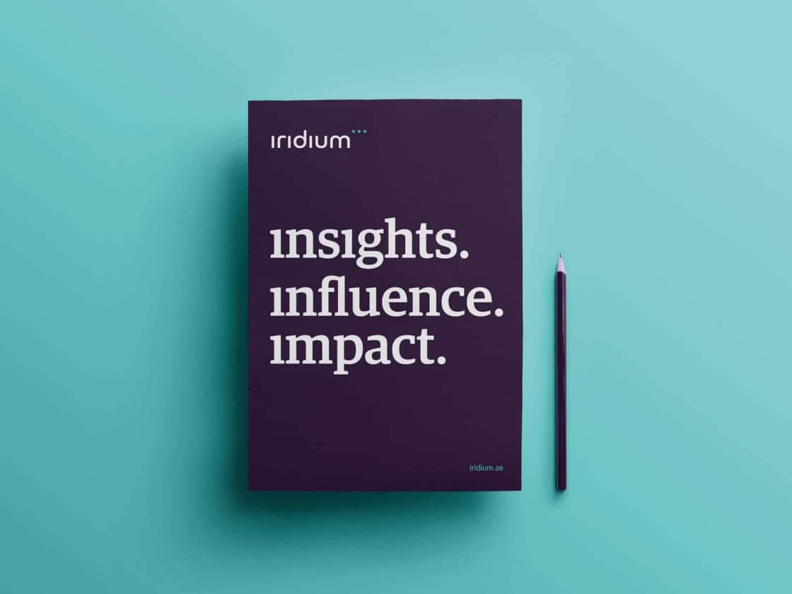 The Iridium Advisors insights, influence, impact report beside a pencil on turquoise | Financial Services Brand Identity, Iridium Advisors