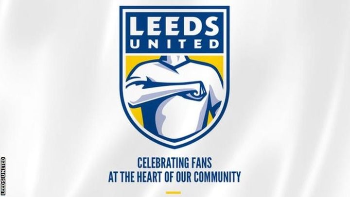 A Leeds United flag reading Celebrating fans at the heart of our community, carrying the club crest.
