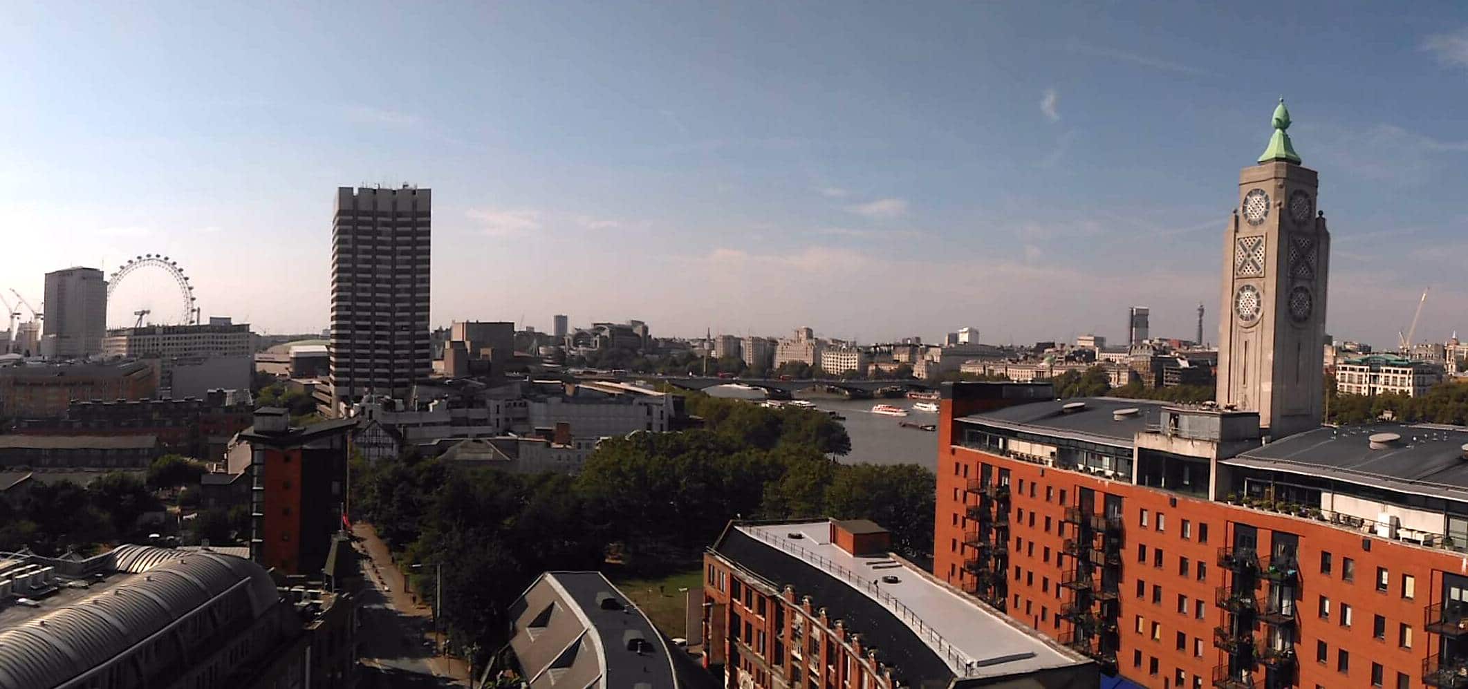 A rooftop view across London at dusk, taking in the Oxo Tower, the London Eye and the river.