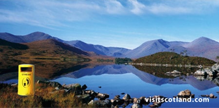 A still Scottish loch reflecting mountains, from a VisitScotland destination marketing campaign.