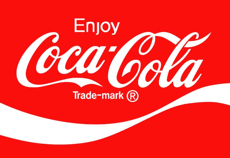 The Enjoy Coca-Cola trademark logo in white on red, the script wordmark that has stayed consistent for over 128 years.