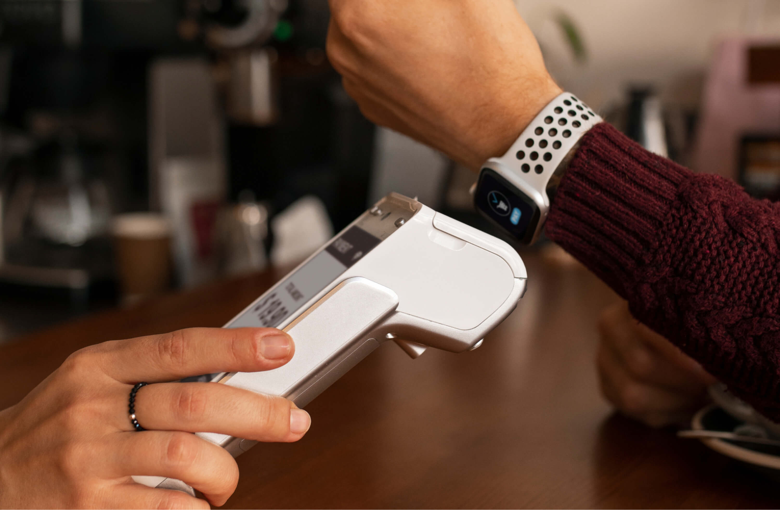 A customer paying by smartwatch on a contactless card terminal | Fintech and Financial Services