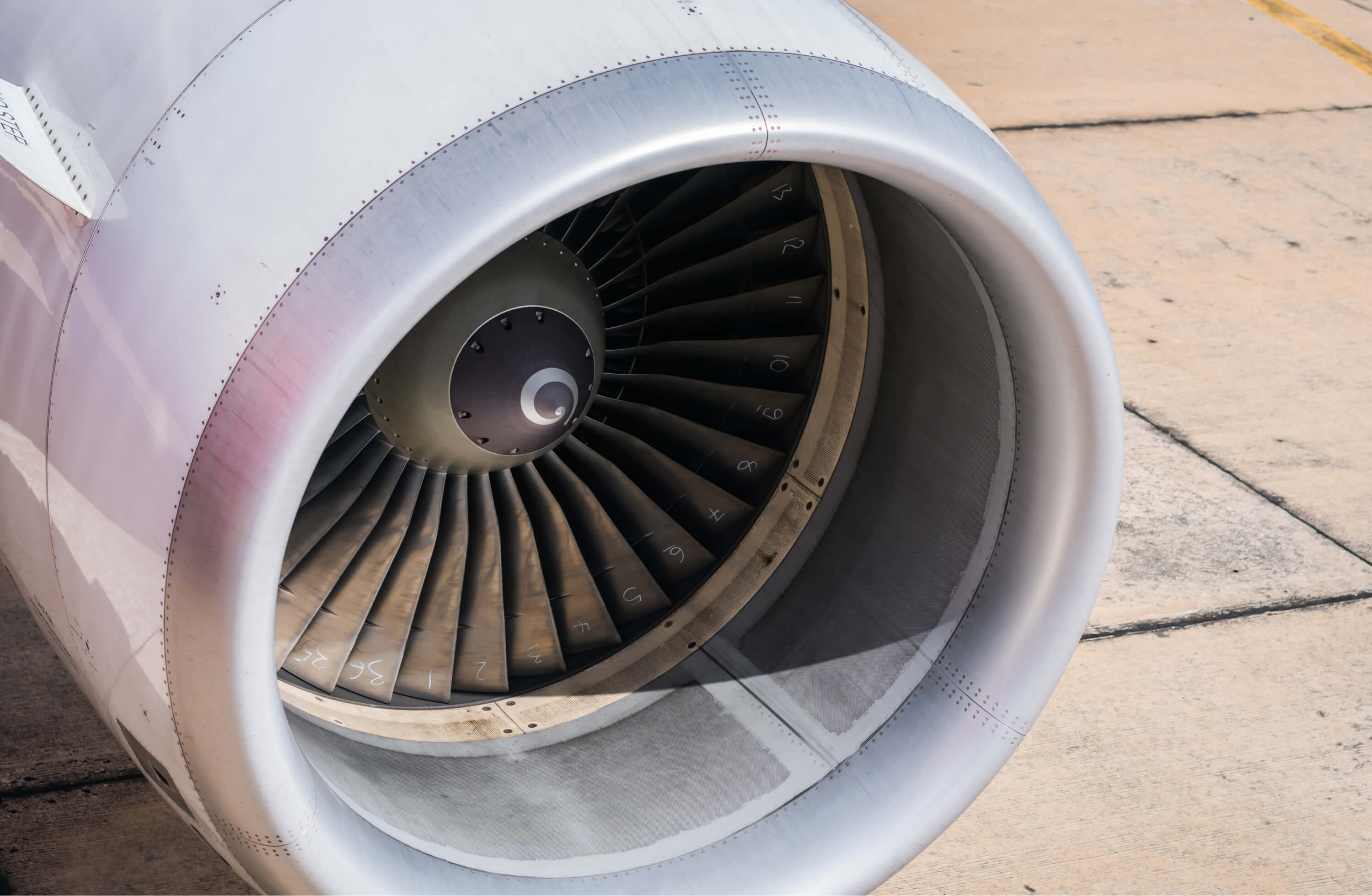 A close-up of a jet engine turbine and cowling on the apron | Aviation and Airline Branding