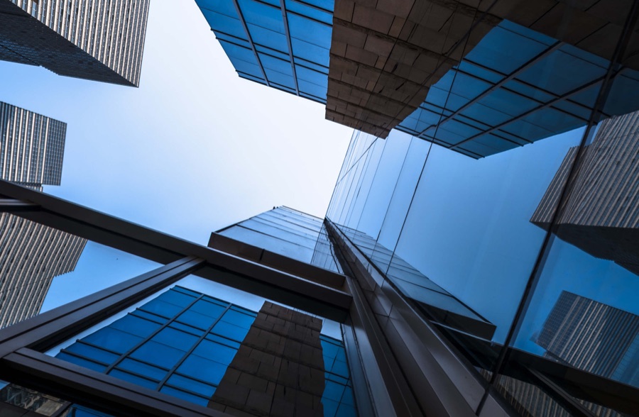 Glass and steel office towers photographed looking straight up | Corporate and B2B