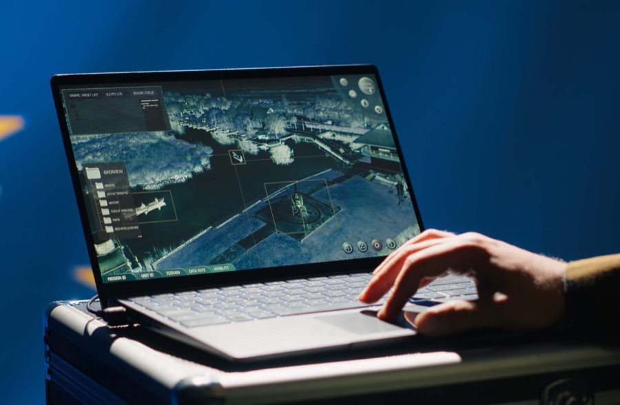 A hand operating a ruggedised laptop showing a satellite mapping interface | Defence and Intelligence