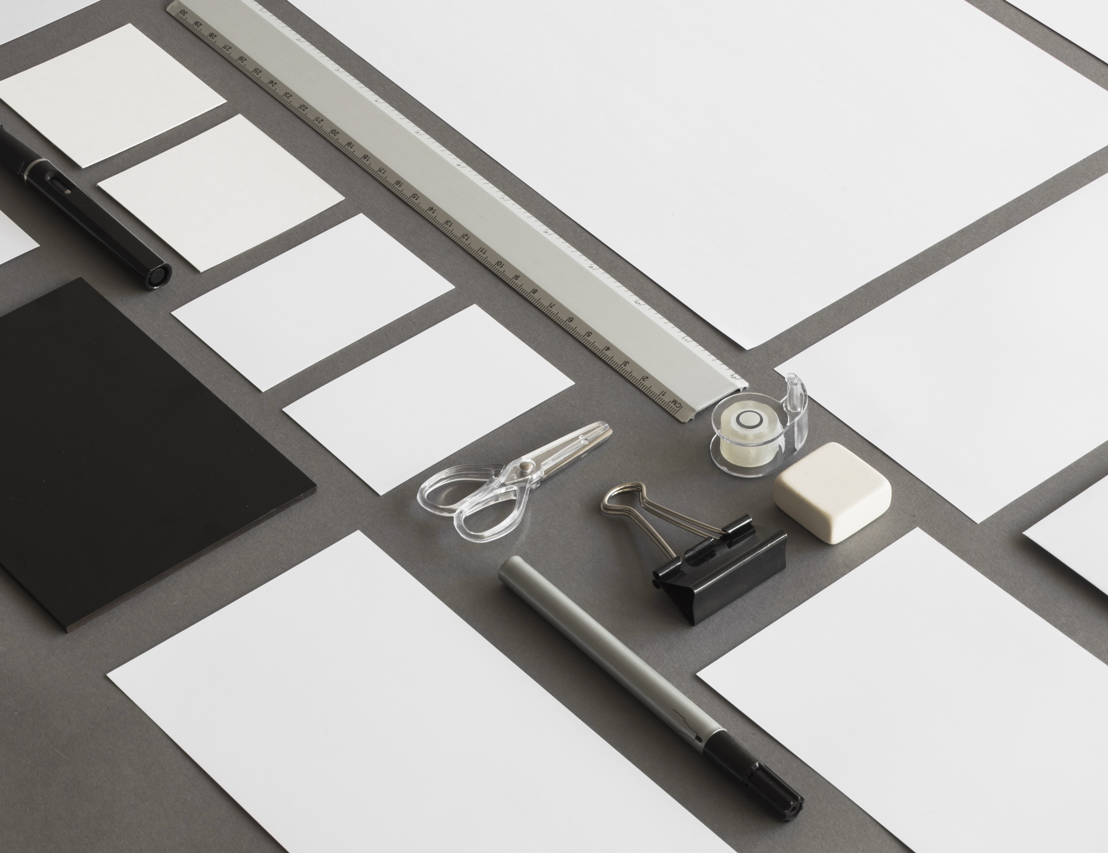 A flat lay of brand stationery, tools and printed elements arranged on a grid | Brand Management