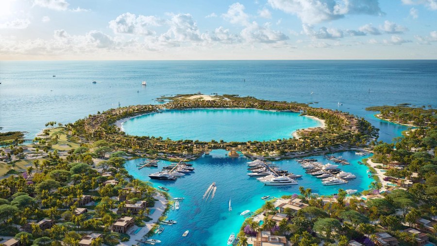 An aerial view of an island destination with a marina, villas and a turquoise lagoon | Destination Branding