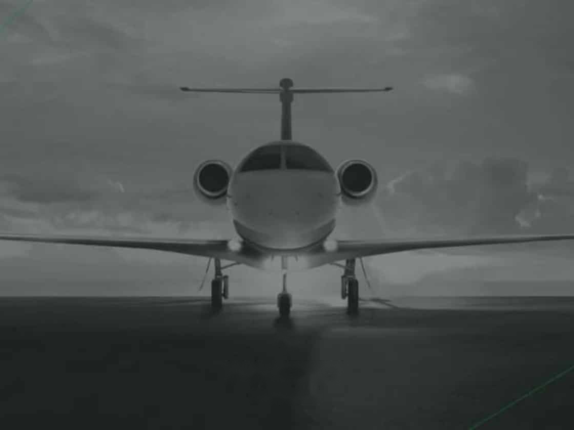 A NASJET business jet head-on on the apron beneath an overcast sky | Private Aviation Brand Identity, NASJET