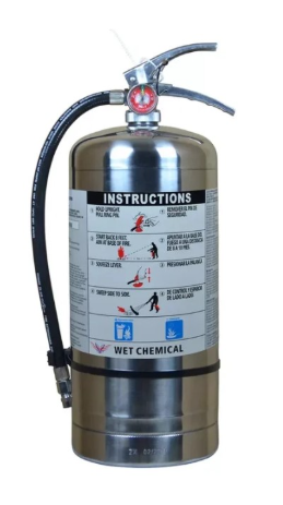 Stainless steel wet chemical fire extinguisher with black hose and lever handle, showing printed instructions and hazard symbols.
