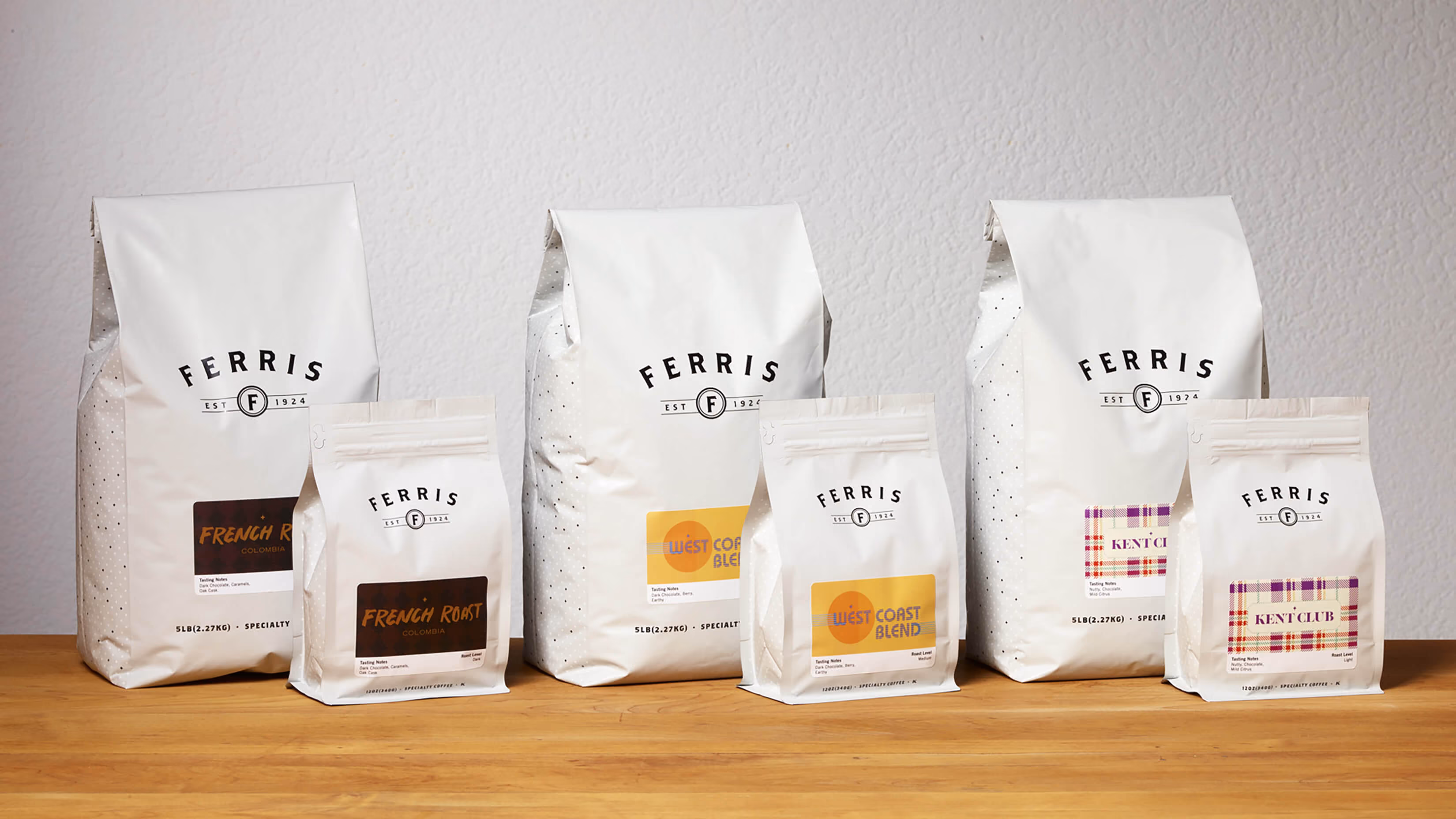 Six Ferris coffee bags in large and small sizes, labeled French Roast Colombia, West Coast Blend, and Kent Club.