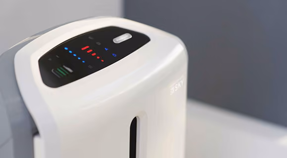 White air purifier device with a control panel showing indicator lights, branded "SKY" on the front panel.