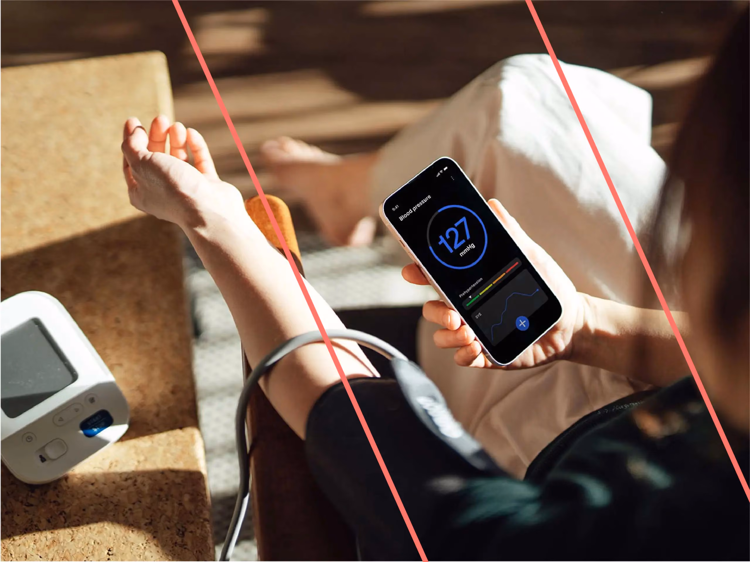 Person wearing a blood pressure cuff views a reading of 127 mmHg on a smartphone app.