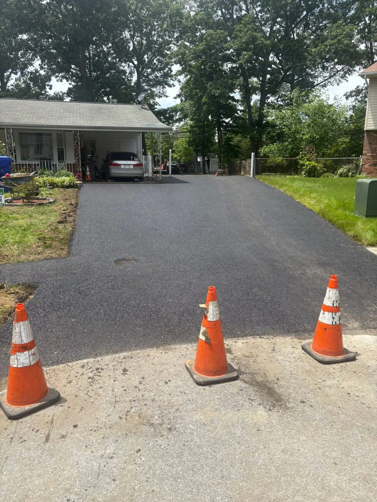 Freshly paved residential asphalt driveway completed by Carino’s Estate Solutions