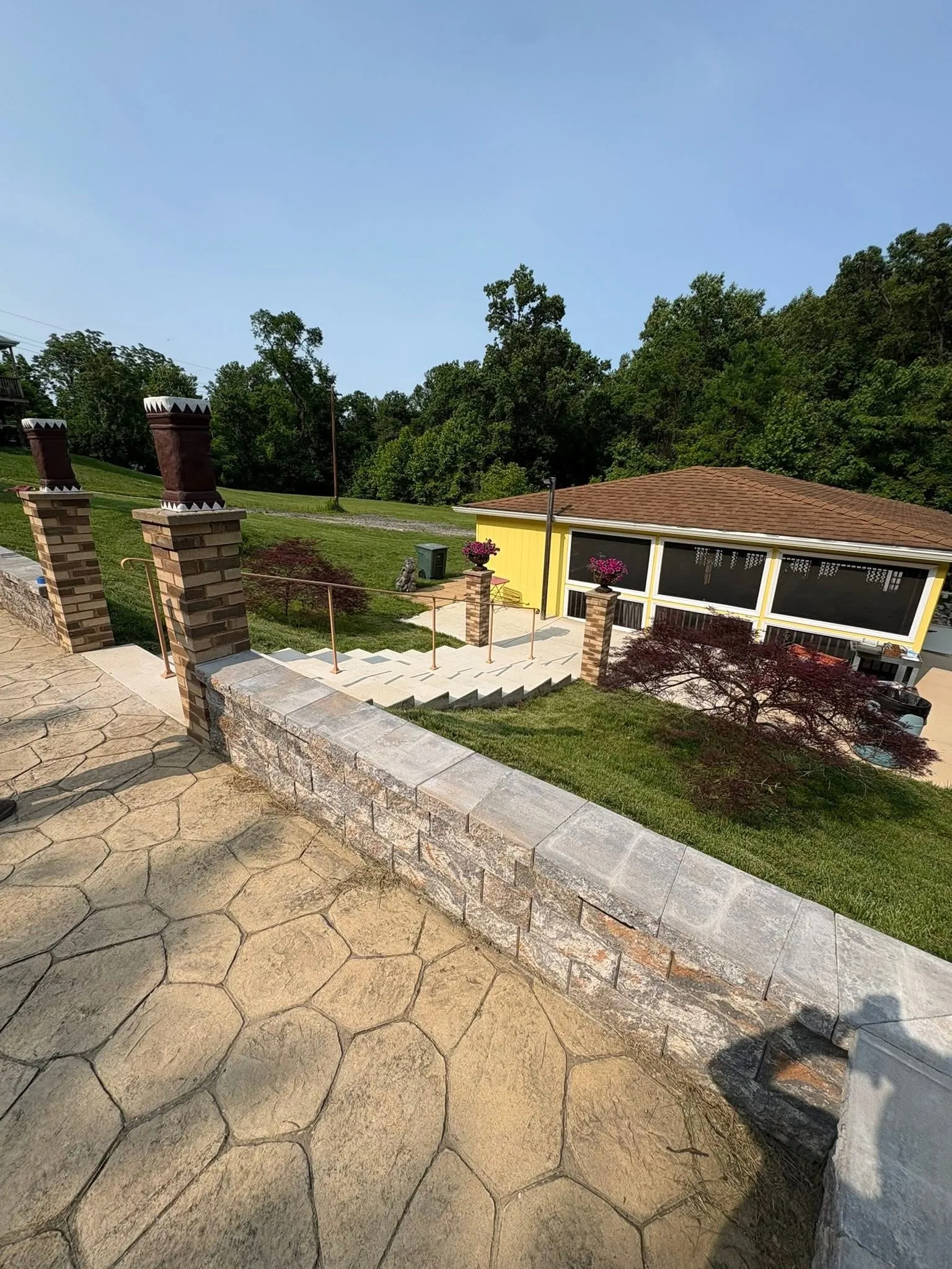 Stamped terrace, masonry walls, exterior stairs and railings completed by CES Construction